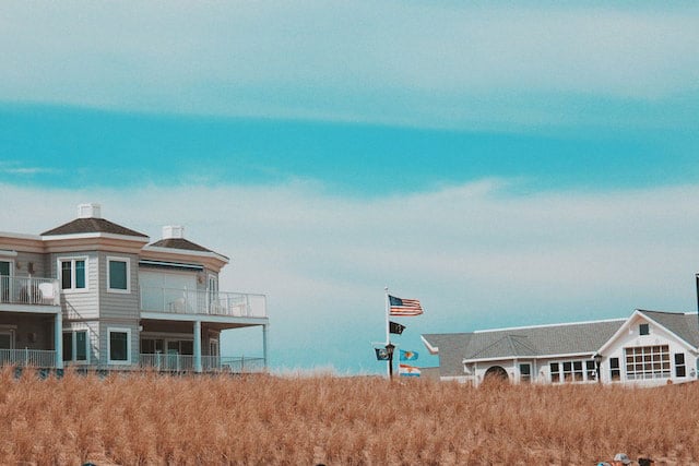American flag waving on a coastal beach