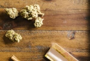 dried cannabis on wooden surface